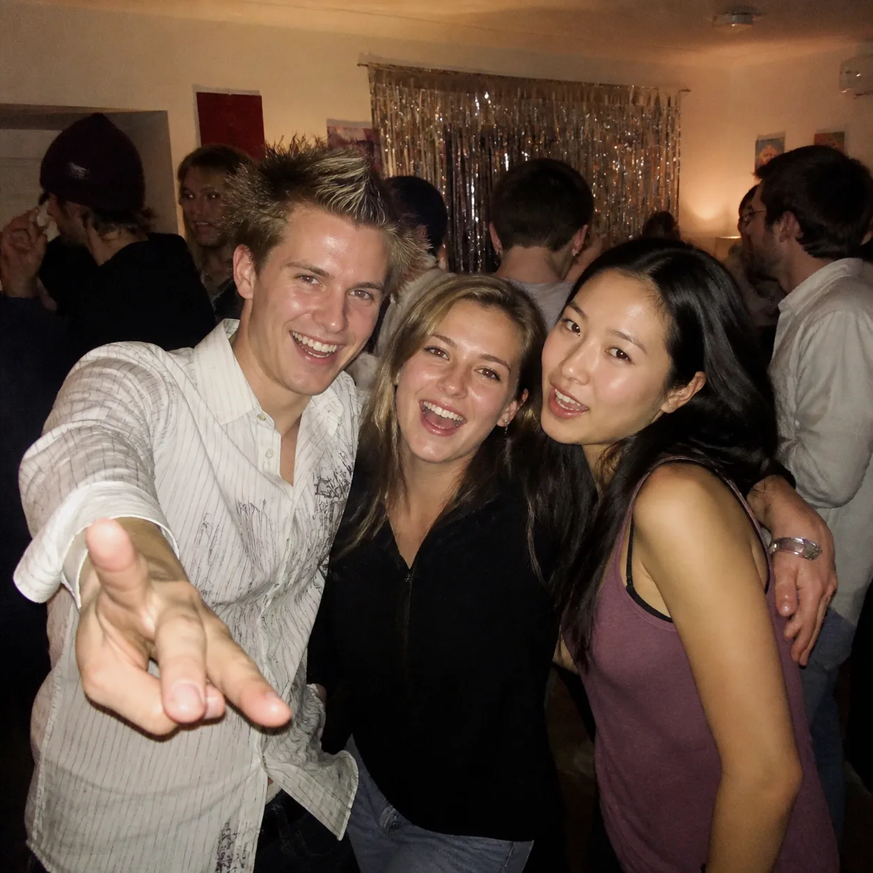 Friends at a party photographed with an early 2000s compact camera